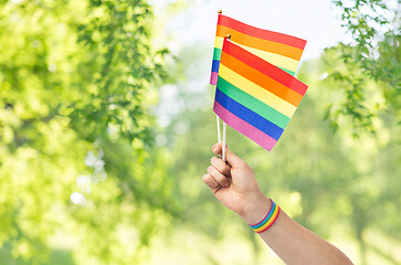 Image showing hand with gay pride rainbow flags and wristband