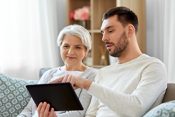 Image showing old mother and adult son with tablet pc at home