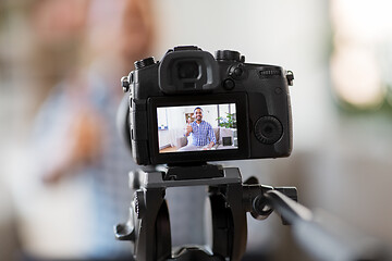 Image showing camera recording video blogger showing thumbs up