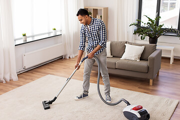 Image showing indian man with vacuum cleaner at home