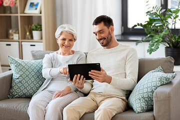 Image showing old mother and adult son with tablet pc at home