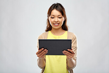 Image showing happy asian woman using tablet computer