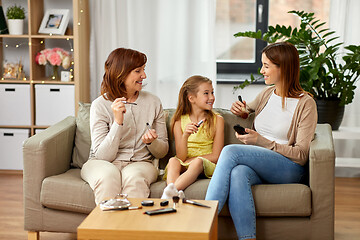 Image showing mother, daughter and grandmother doing make up