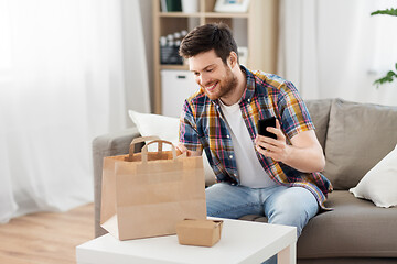 Image showing man checking takeaway food order at home