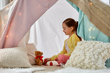 Image showing girl playing tea party with teddy in kids tent