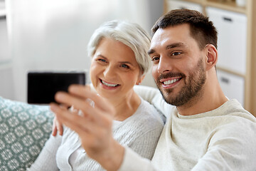 Image showing senior mother with adult son taking selfie at home