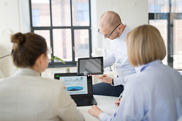 Image showing close up of business team with tablet pc at office