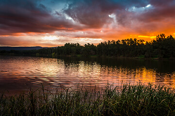 Image showing Stormy sunset over water