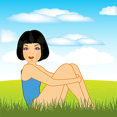 Image showing Beautiful girl sits on green year glade