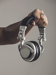 Image showing DJ holding him headphones