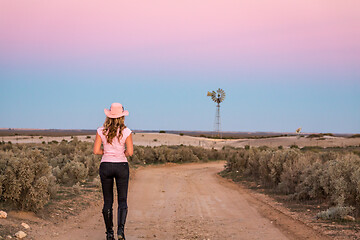 Image showing Walking along dirt road of vast open spaces of outback