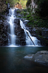 Image showing Waterfall tumbling over a ledge into a beautiful swimming hole b