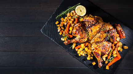 Image showing Butterflied grilled whole chicken with roasted vegetables and potatoes 