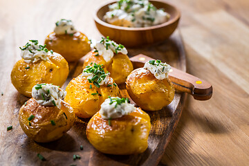 Image showing Oven baked potatoes with sour cream with butter and chives