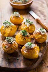 Image showing Oven baked potatoes with sour cream with butter and chives