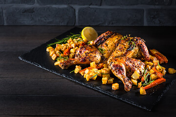 Image showing Butterflied grilled whole chicken with roasted vegetables and potatoes 