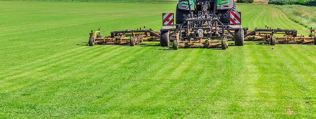 Image showing Industrial lawn mower cutting the grass