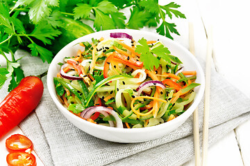 Image showing Salad of cucumber in bowl on light board