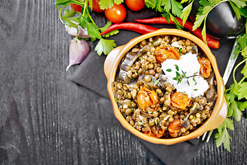 Image showing Lentils with eggplant and tomatoes in bowl on dark board top