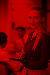 Image showing blonde businesswoman working on tablet at office