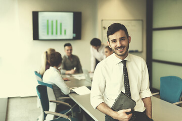 Image showing young business man with tablet at office meeting room