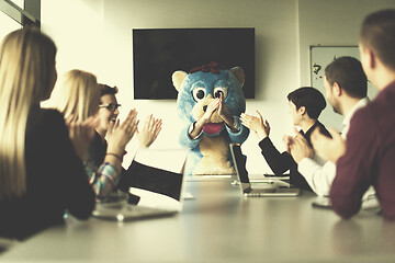 Image showing boss dresed as bear having fun with business people in trendy of