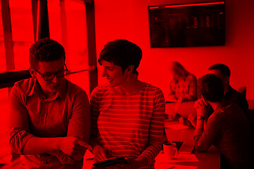 Image showing Two Business People Working With Tablet in office