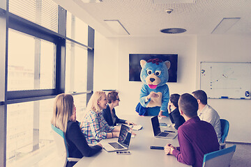 Image showing boss dresed as bear having fun with business people in trendy of