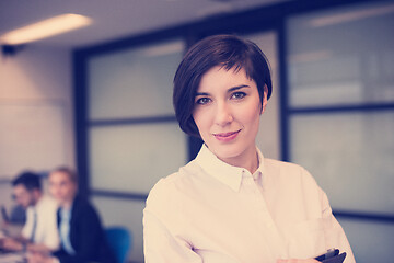 Image showing hispanic businesswoman with tablet at meeting room