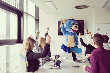 Image showing boss dresed as bear having fun with business people in trendy of