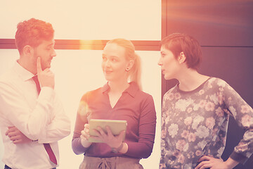 Image showing young business people group working on tablet computer with sunr