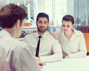 Image showing young couple signing contract documents on partners back