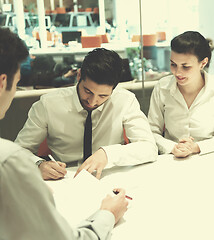 Image showing young couple signing contract documents on partners back