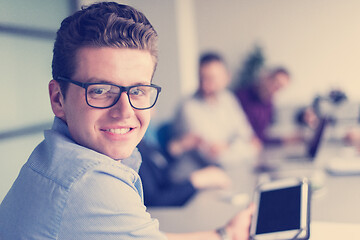 Image showing Businessman using tablet in modern office