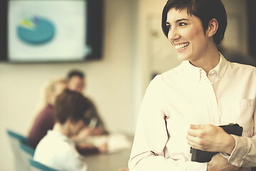 Image showing hispanic businesswoman with tablet at meeting room