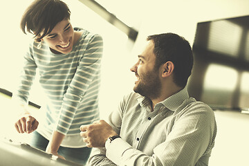 Image showing Two Business People Working With Tablet in startup office