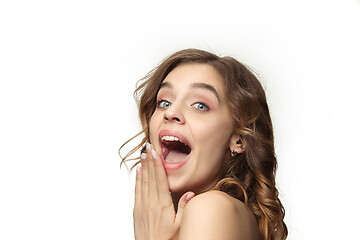 Image showing Nice young smiling woman with long wavy silky hair, natural make up looking at camera