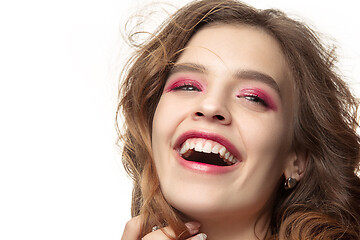 Image showing Nice young smiling woman with long wavy silky hair, natural make up looking at camera