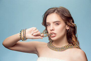 Image showing Beautiful young girl in studio with pearl jewelry - earrings, bracelet, necklace.