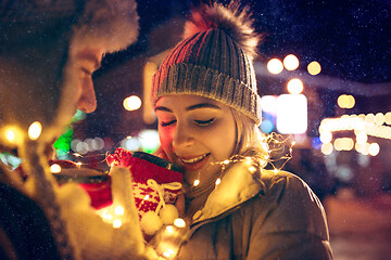 Image showing Adult couple hanging out in the city during Christmas time