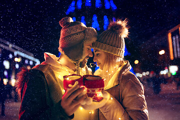 Image showing Adult couple hanging out in the city during Christmas time