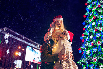 Image showing family, christmas, holidays, season and people concept - happy family over city background and snow