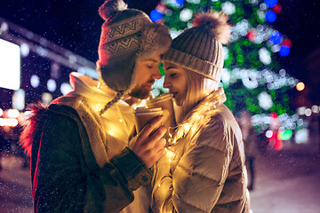 Image showing Adult couple hanging out in the city during Christmas time