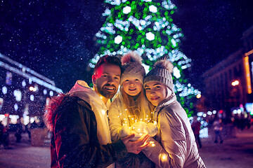 Image showing family, christmas, holidays, season and people concept - happy family over city background and snow