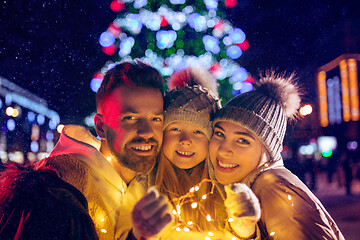 Image showing family, christmas, holidays, season and people concept - happy family over city background and snow