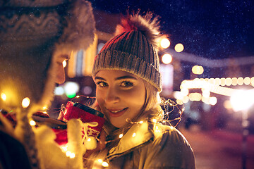 Image showing Adult couple hanging out in the city during Christmas time