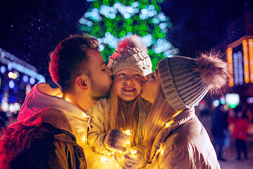 Image showing family, christmas, holidays, season and people concept - happy family over city background and snow