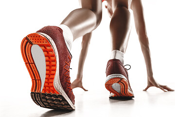 Image showing Portrait of young sporty woman at starting block of race isolated over white background