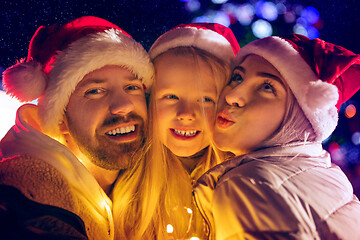 Image showing family, christmas, holidays, season and people concept - happy family over city background and snow