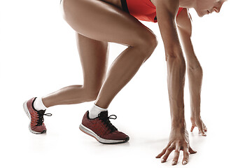 Image showing Portrait of young sporty woman at starting block of race isolated over white background